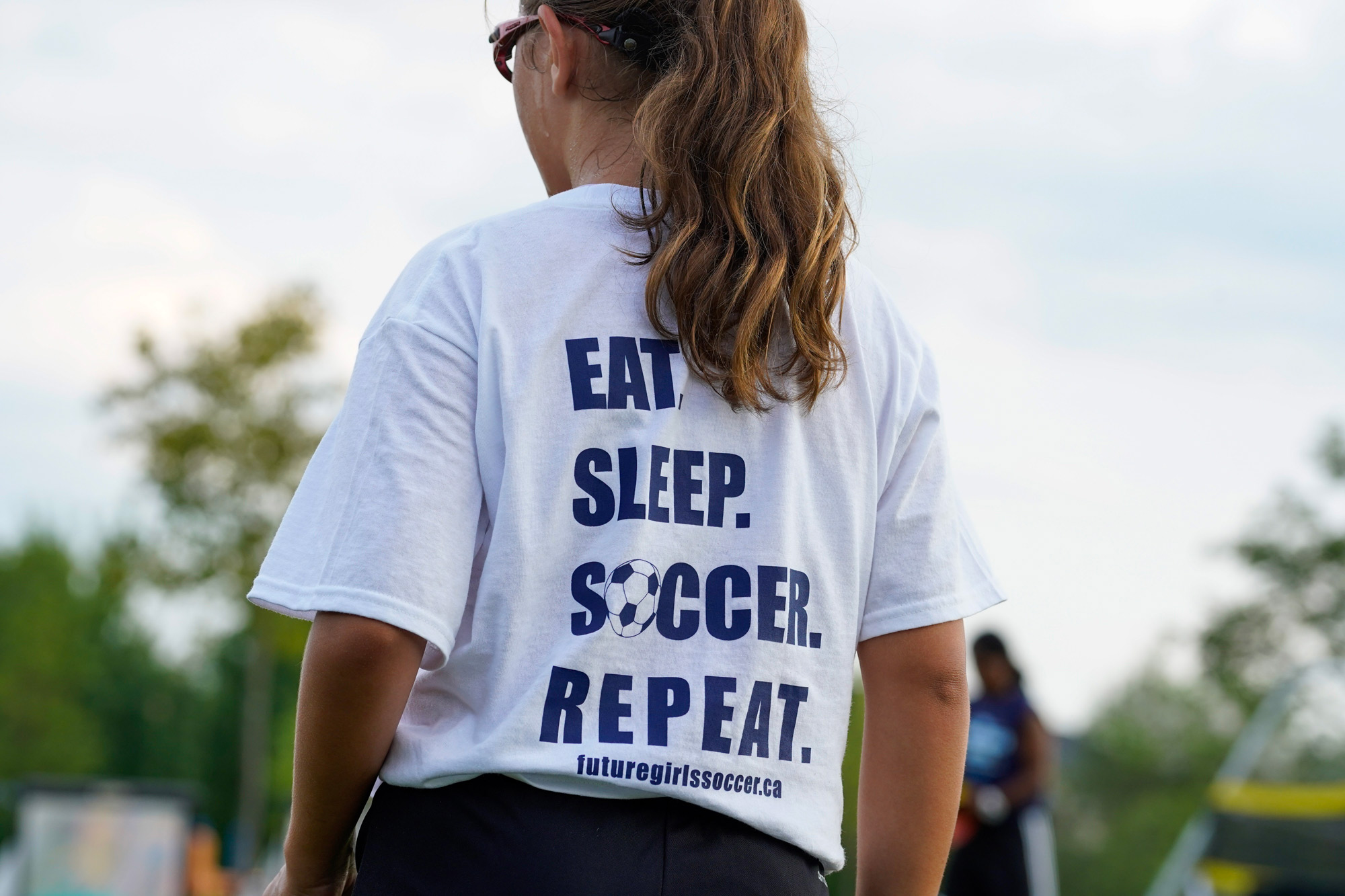 Girl Wearing A T-shirt Which Reads Eat. Sleep. Soccer. Repeat.